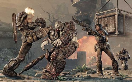 Two female characters taking down a Locust soldier in Gears of War 3.
