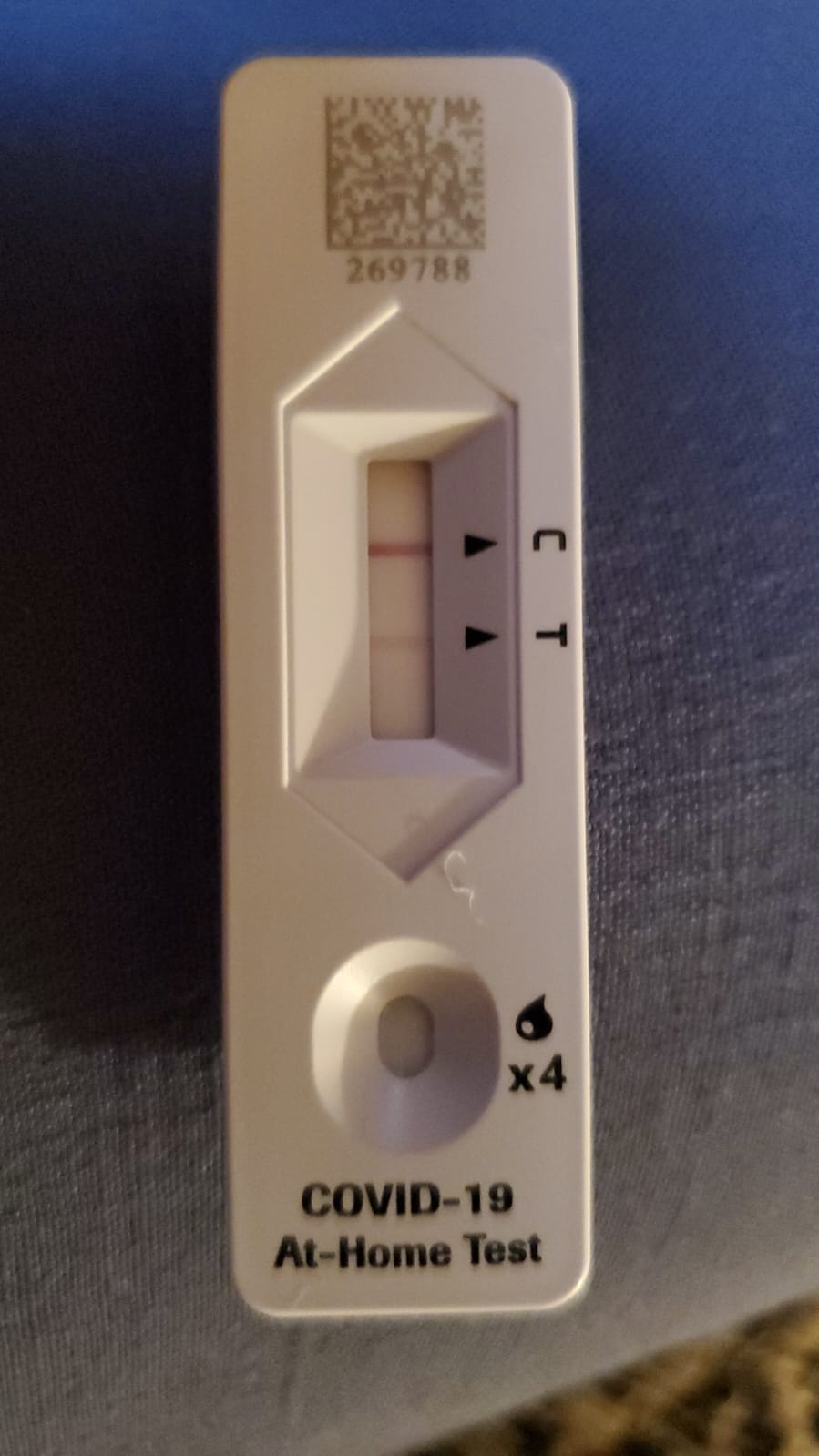 A positive covid-19 at-home test, with a very faint line indicating that it's positive.