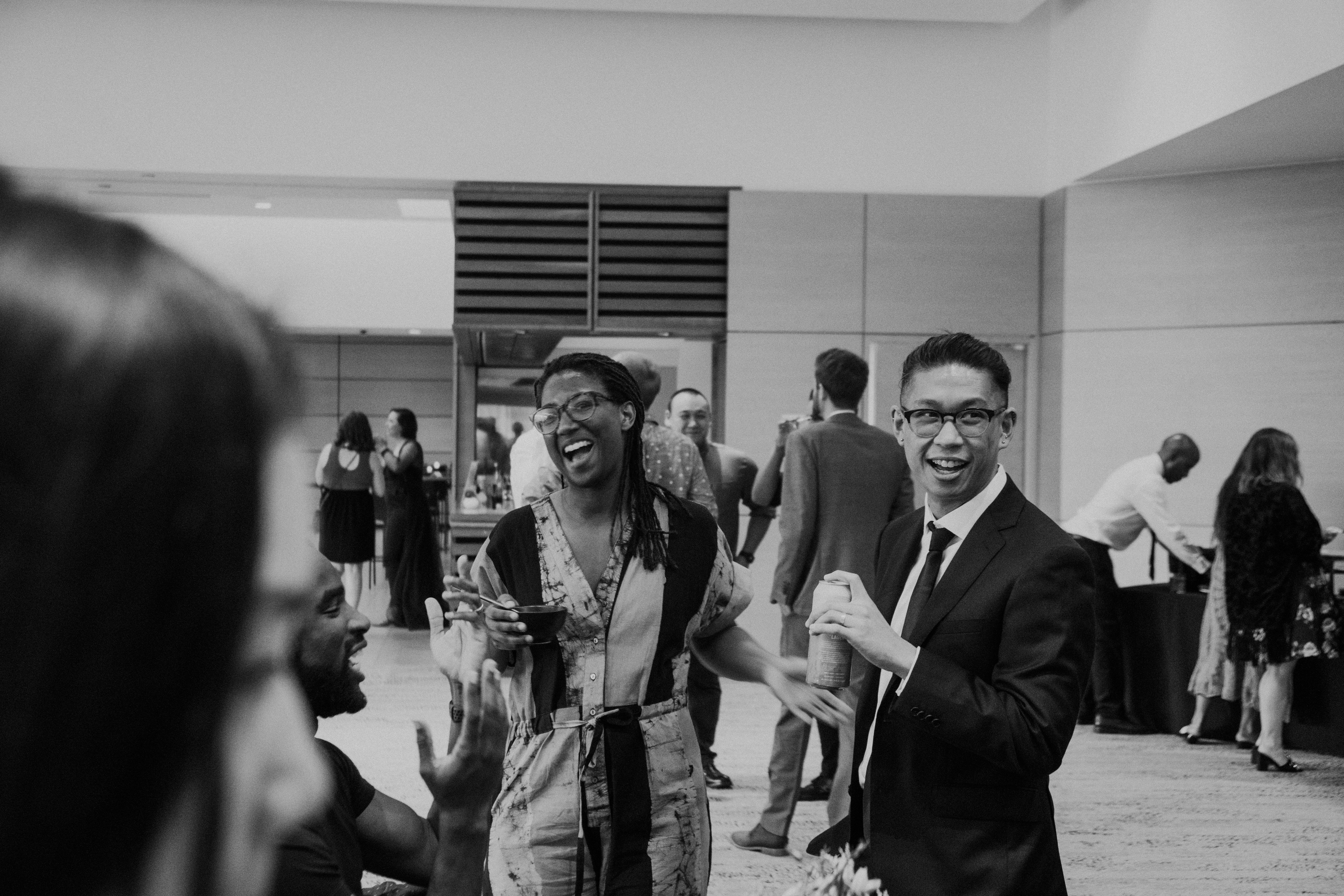 A black-and-white photograph of smiling guests at a formal event, including the writer of this blog post.